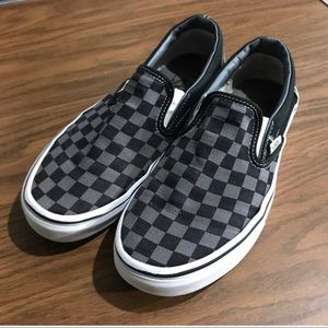 Black and grey checkered Vans slip on